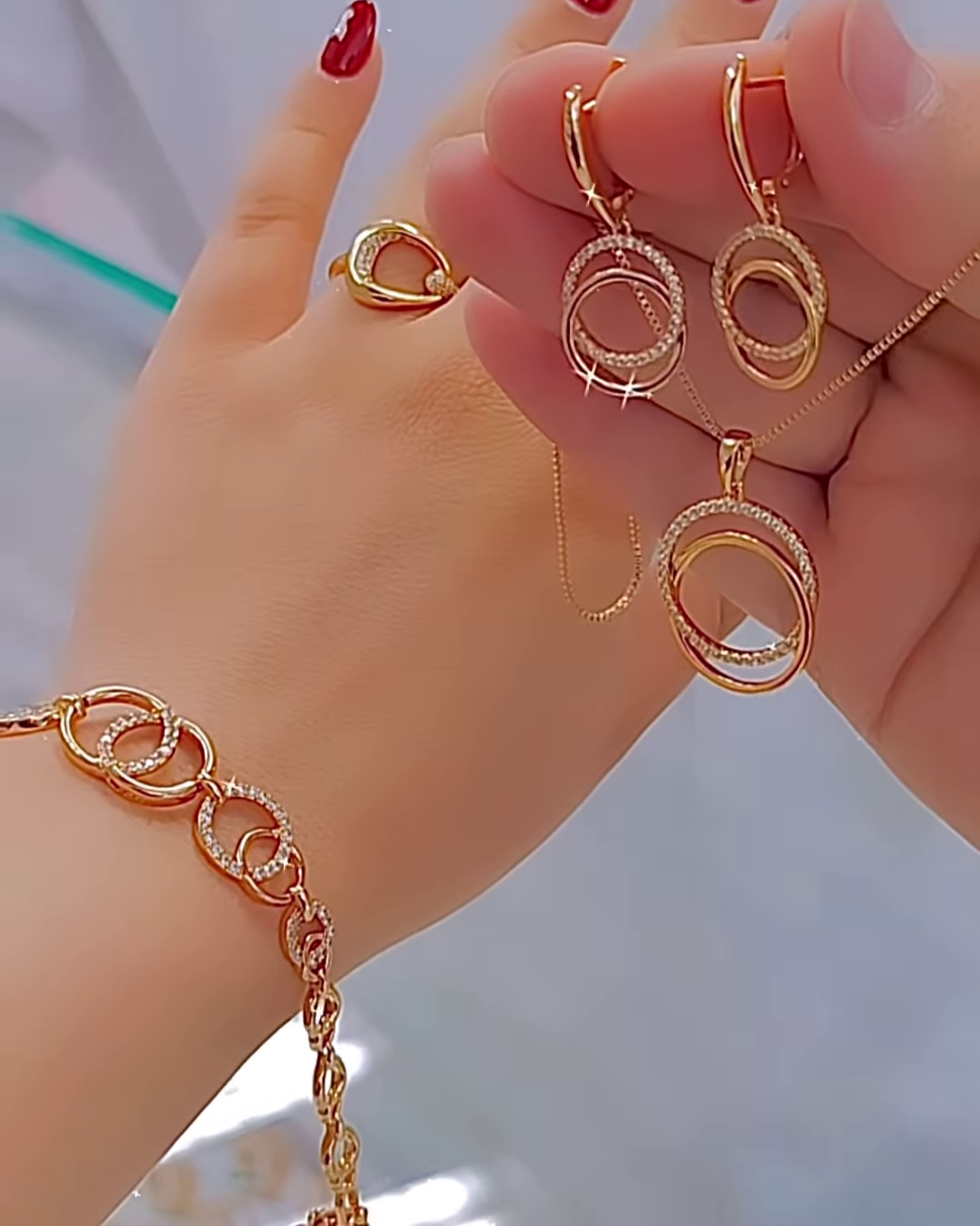 Elegant Rose Gold Tone Jewelry Set with Interlocking Circle Design and Sparkling Accents - Image 2