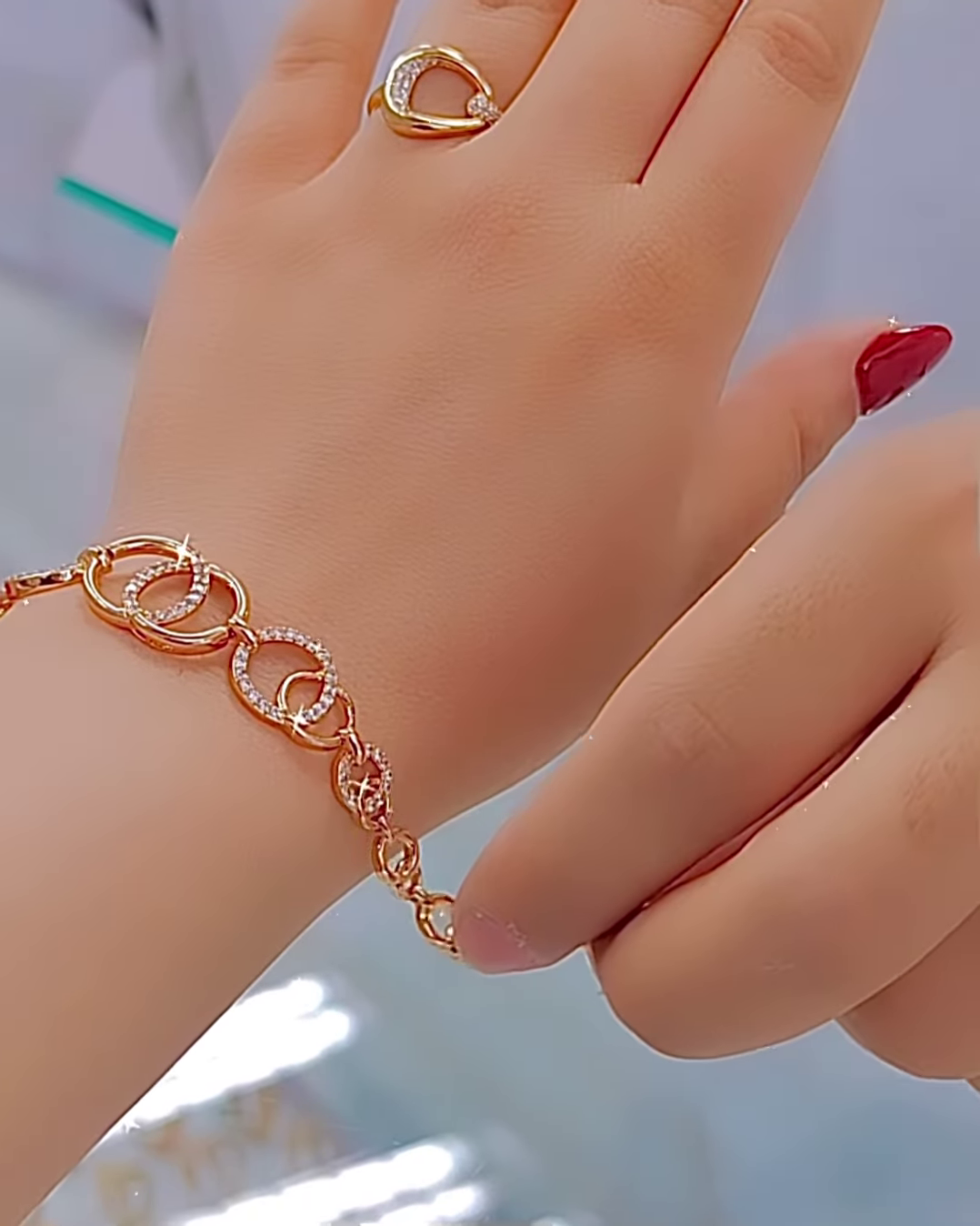 Elegant Rose Gold Tone Jewelry Set with Interlocking Circle Design and Sparkling Accents - Image 3